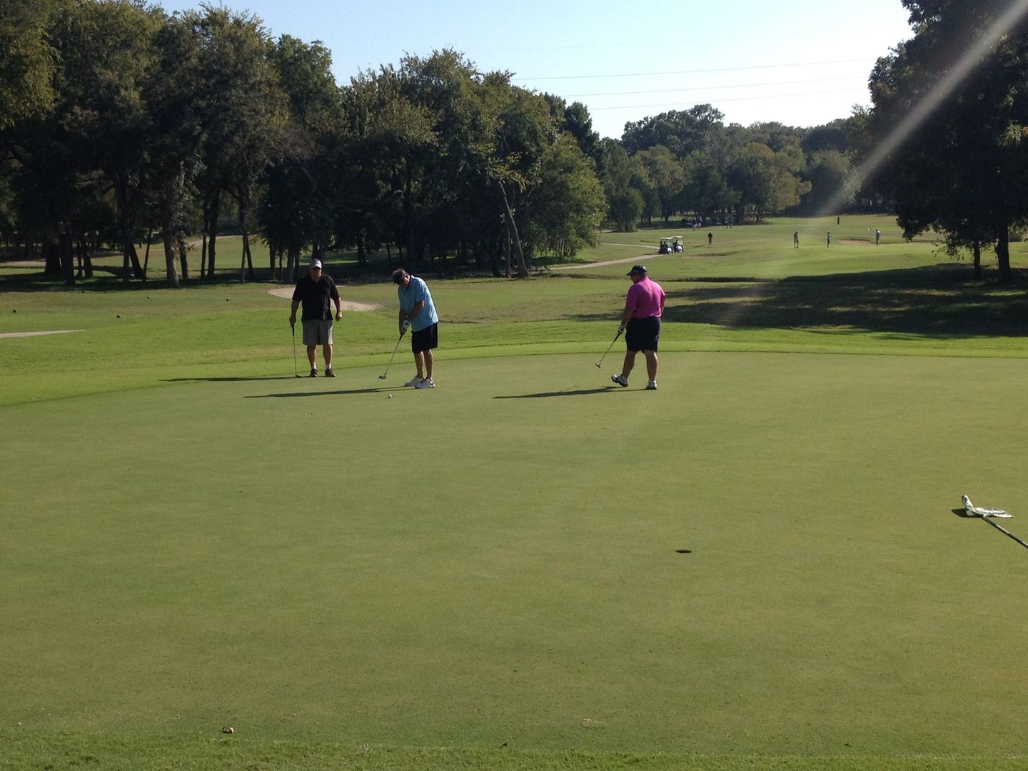 Scenic view of the Lakes Course fairway with trees and water