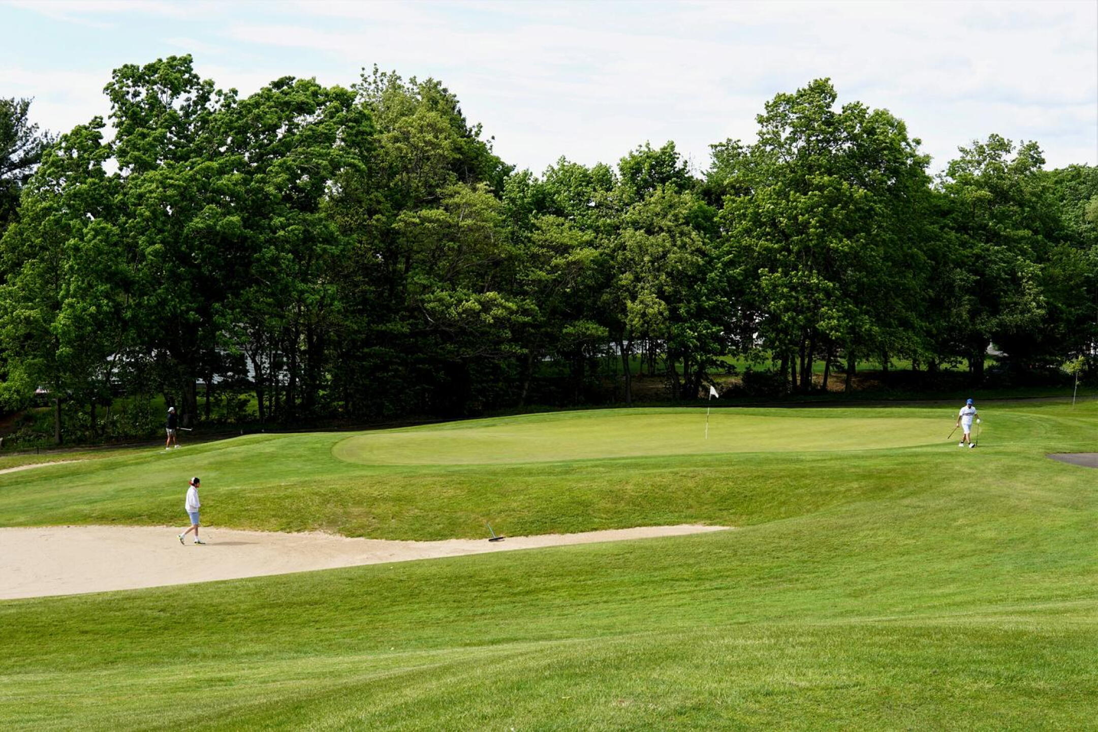 A threesome, playing out the first hole around its elevated, well-trapped green. (Photo submitted by AptlyLinked on 05/20/2023)