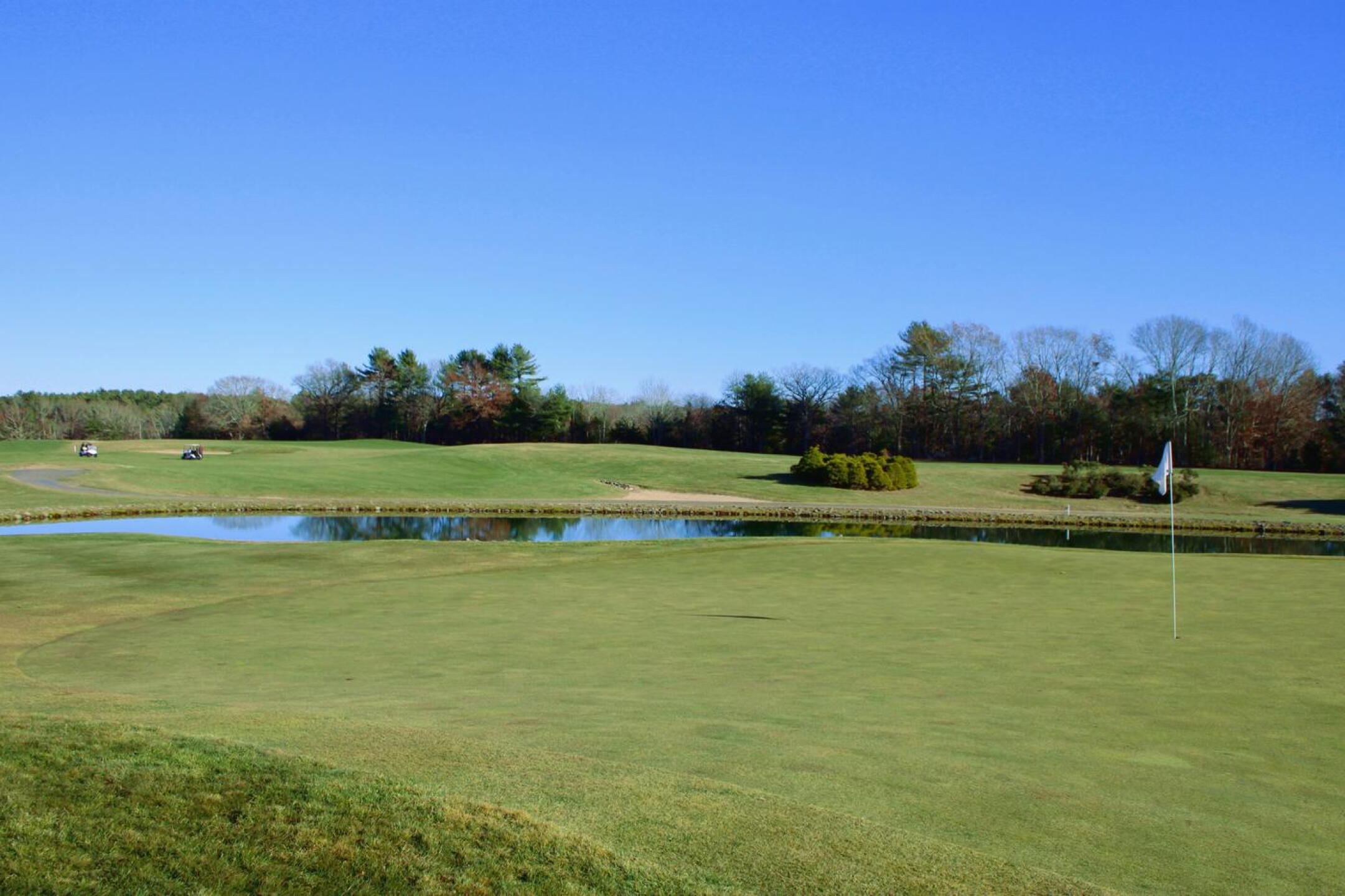 Hole six, par-3, 181: Set by a pond and further guarded by a left-side bunker, the green undulates mildly. (Photo submitted by AptlyLinked on 11/23/2024)