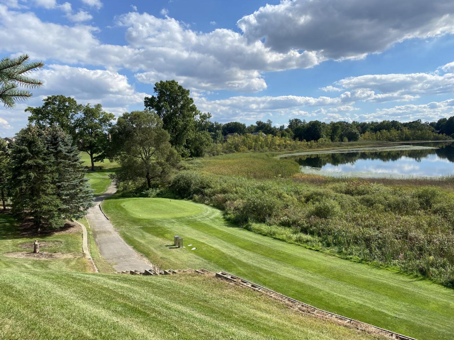 View of the 10th tee box from the banquet patio.  One of the toughest tee shots on the course from the blues.  A 180 yard carry to the start of the fairway with water left, and out of bounds right. (Photo submitted by BuffaloBen15 on 01/04/2022)