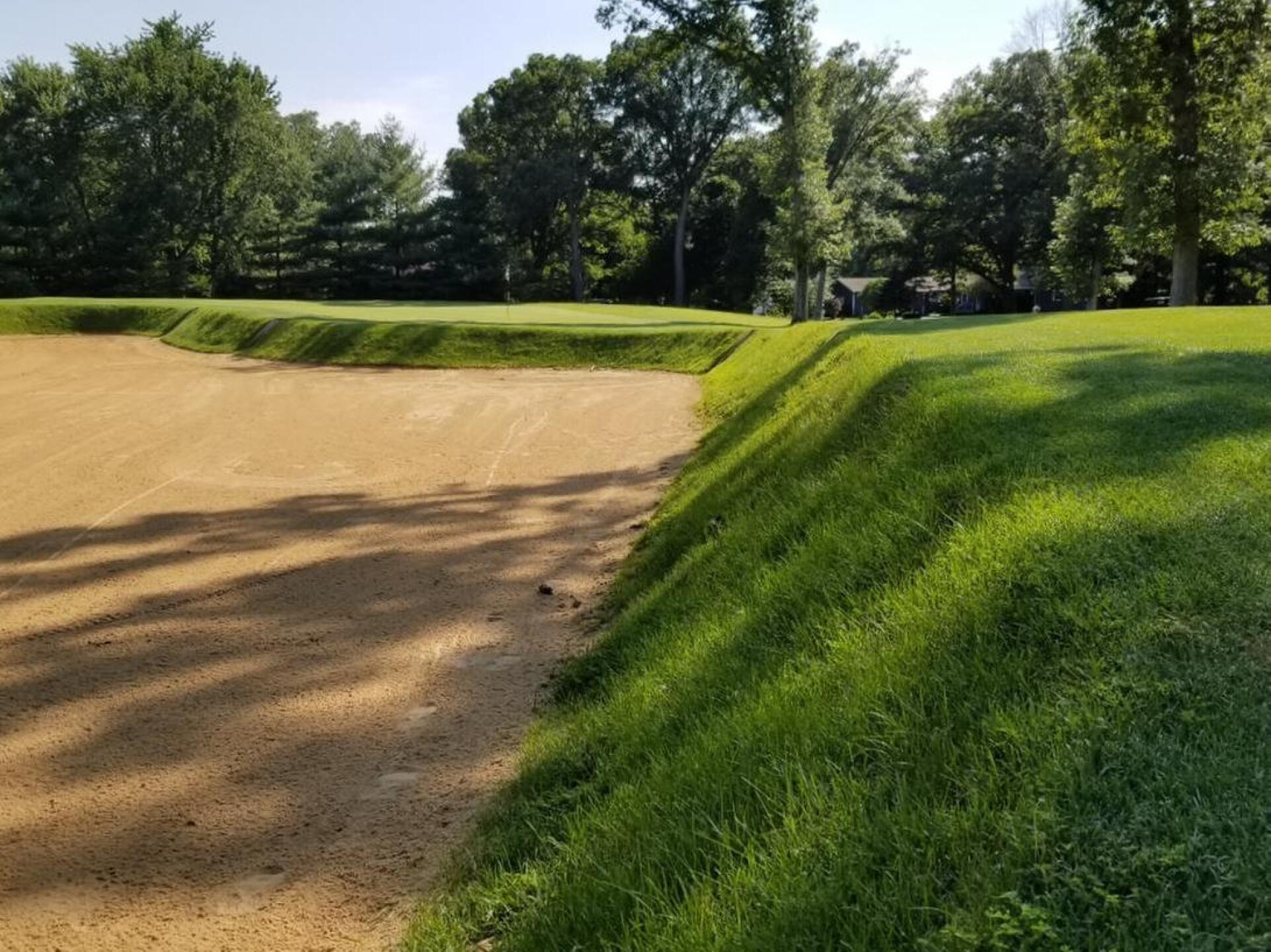 A massive fall-off bunker guards the par 3 thirteenth (Photo submitted by Brookscm72 on 07/30/2018)