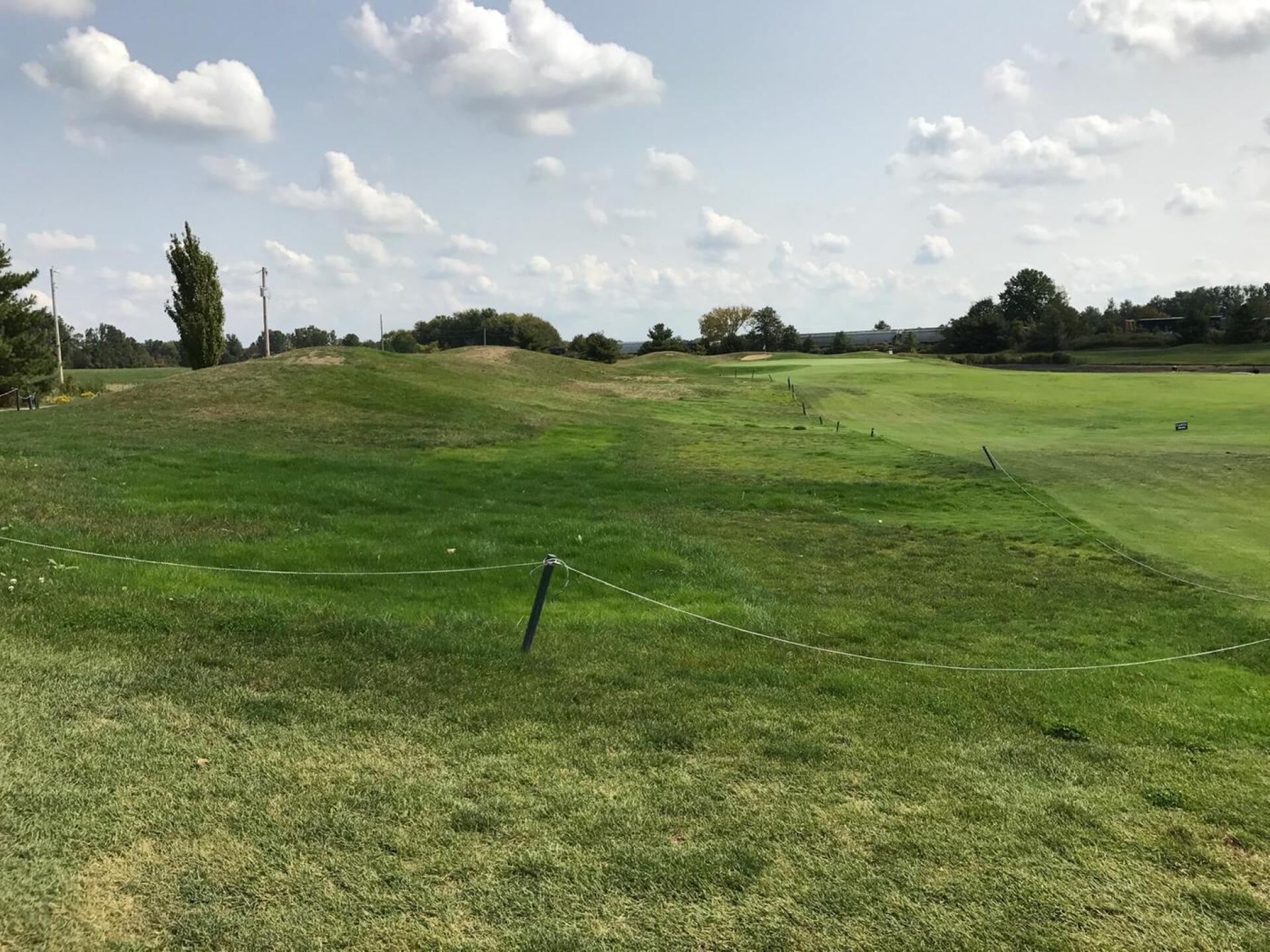 First hole from second shot area, see roped off grass on left mounds. (Photo submitted by carolinadad on 09/24/2017)
