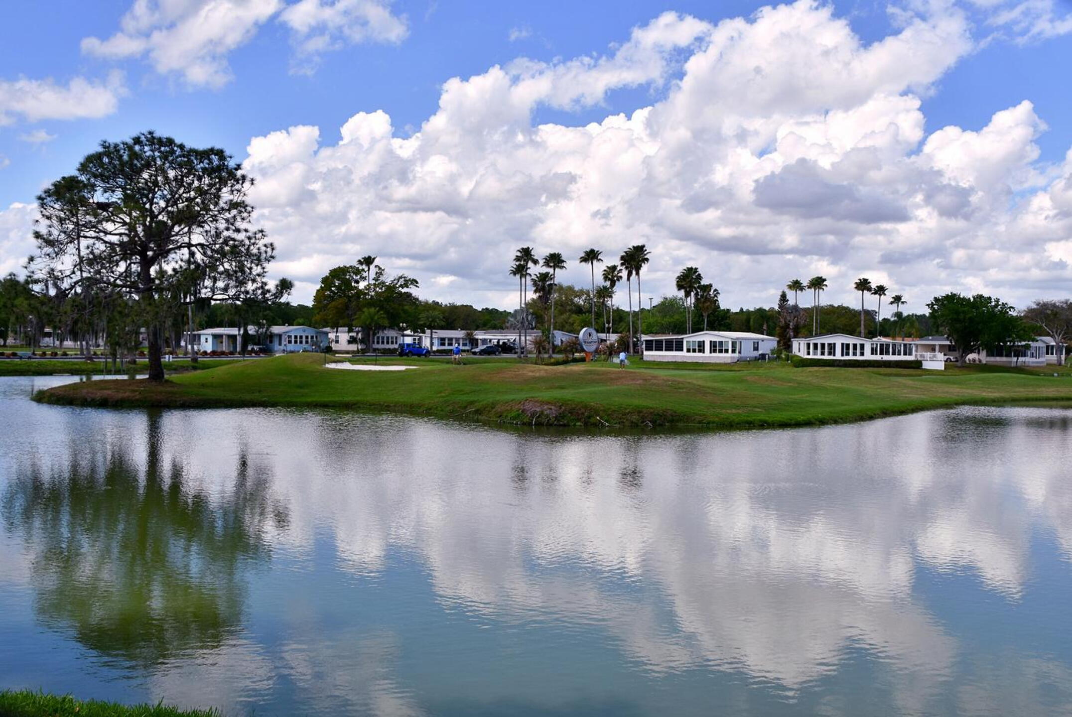 A view of the par-3, 186-yard sixth hole from its left side, across the pond that nearly encircles its green complex. (Photo submitted by AptlyLinked on 03/14/2026)