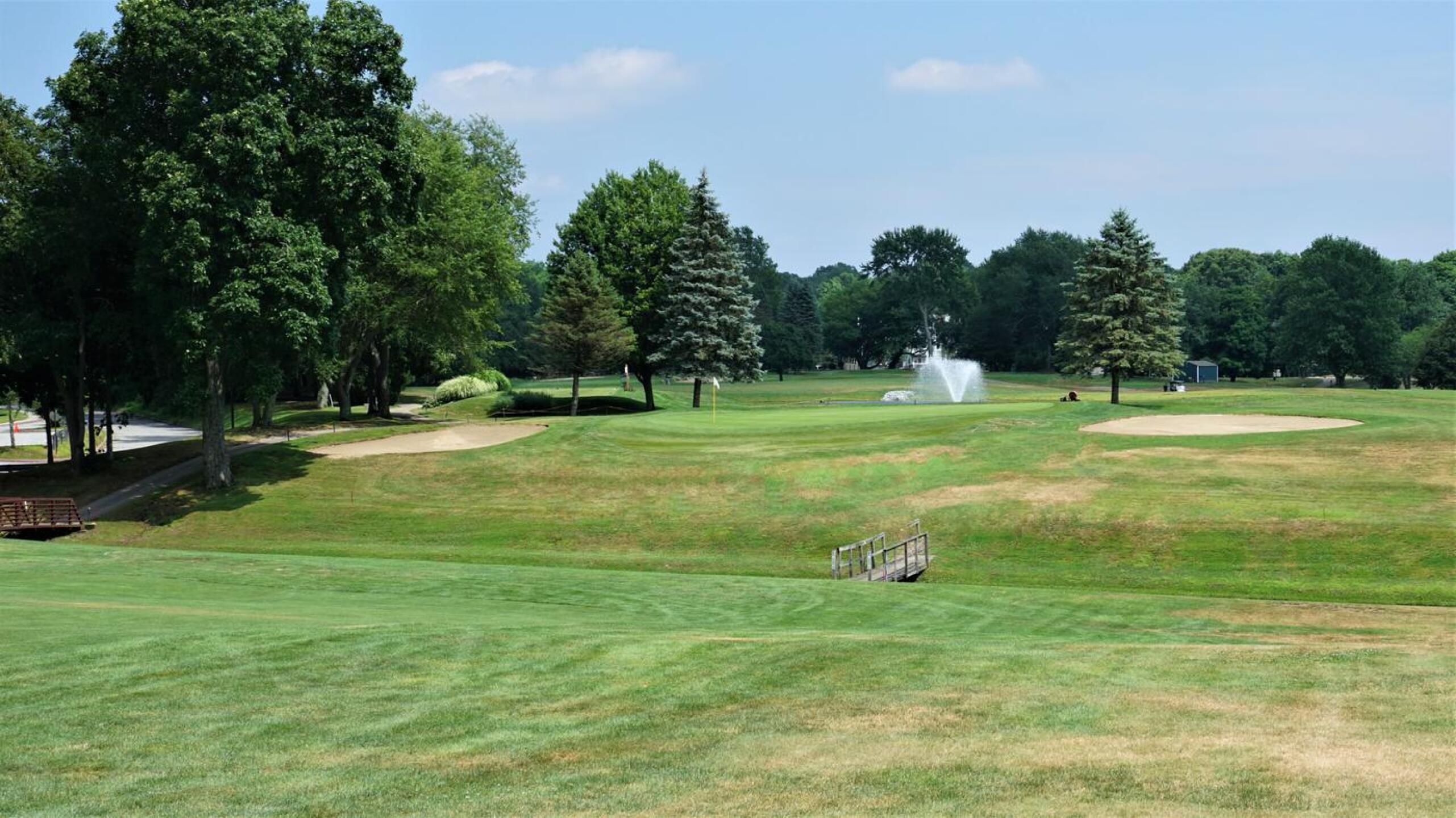 The fourteenth green, at 560 yards, will take two Herculean shots to reach in two, but anything less may find its way into the small brook before it. (Photo submitted by AptlyLinked on 07/22/2020)