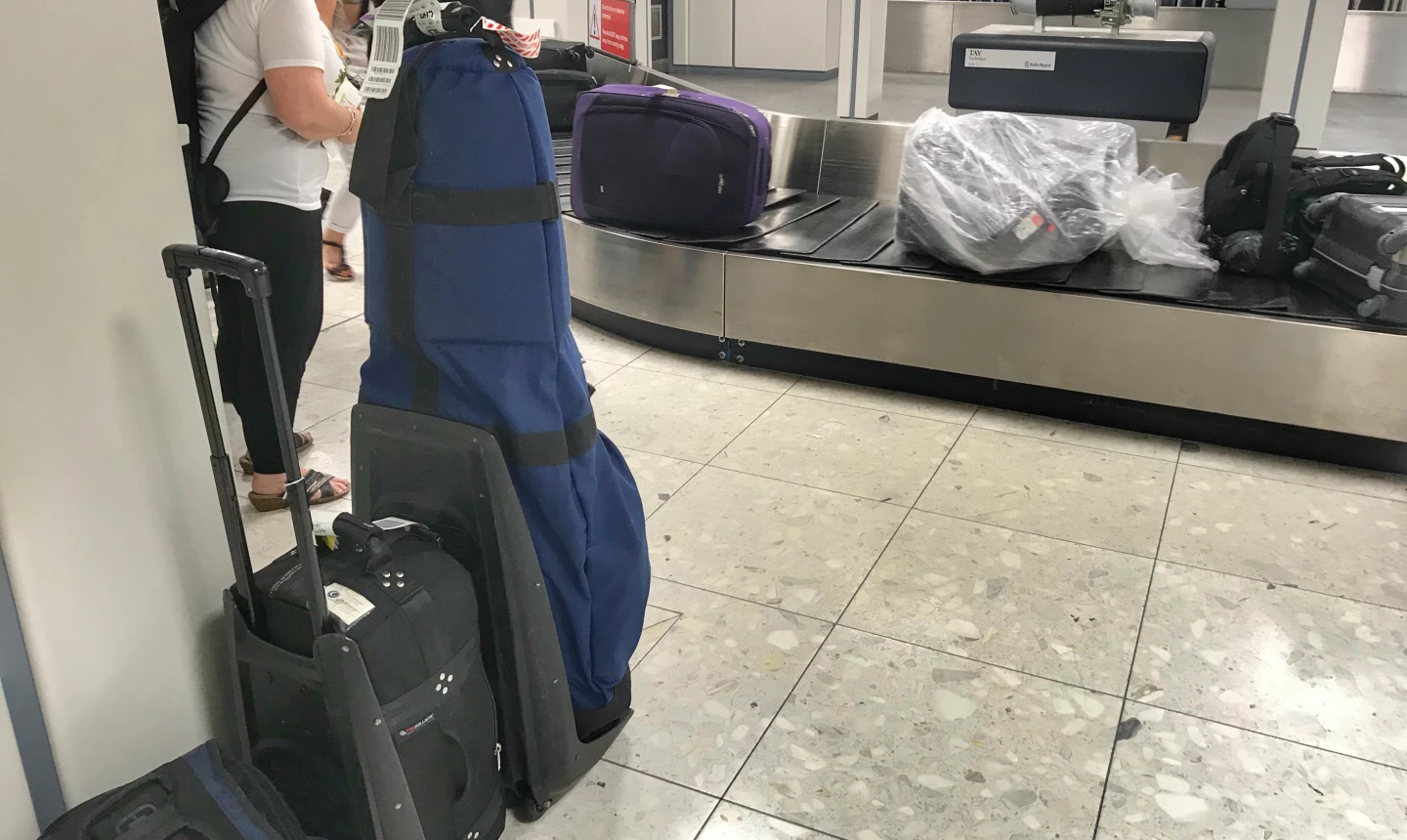 Baggage claim and golf clubs
