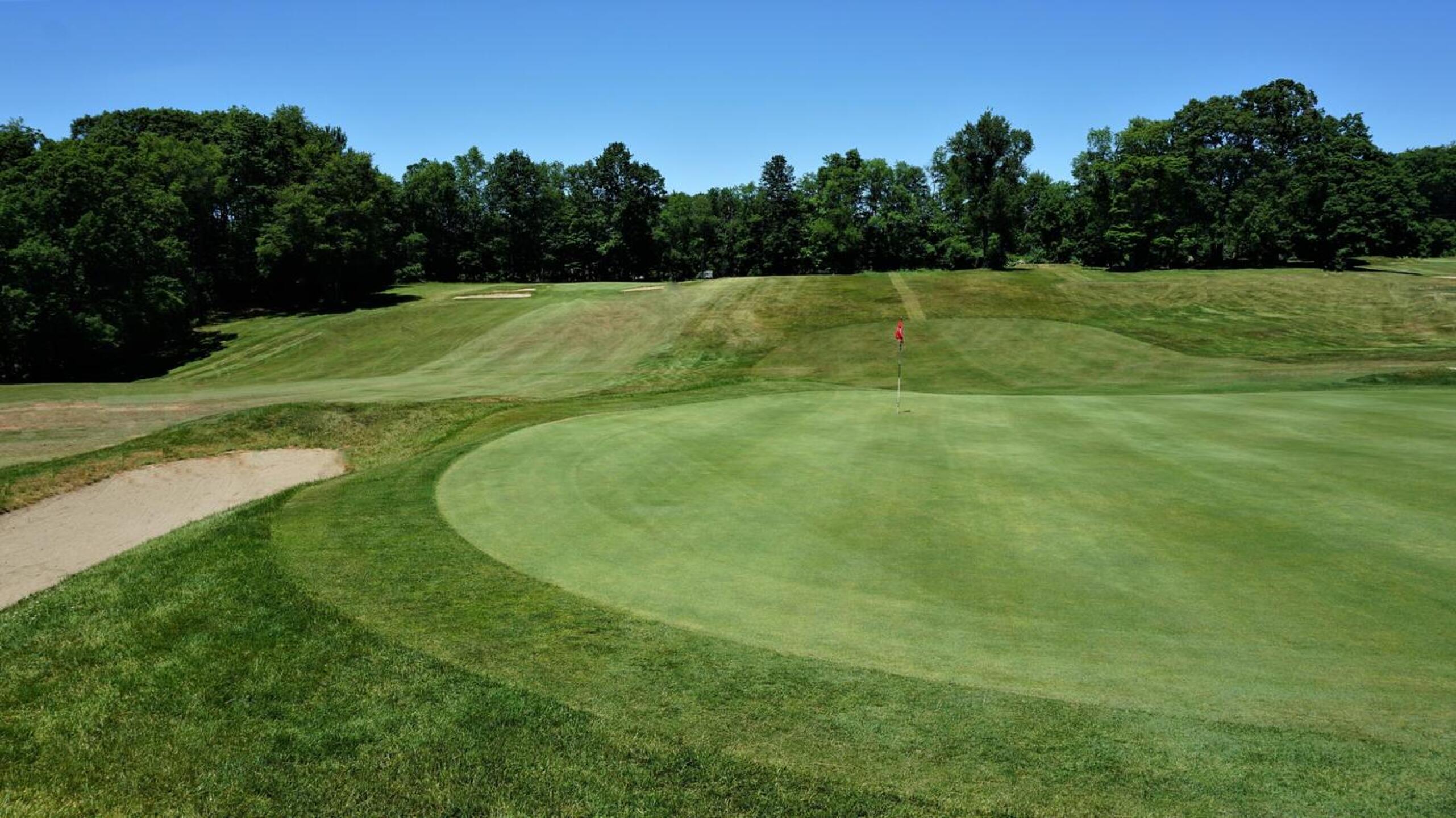 6th: Outstanding 194-yard three-par played over same valley as previous hole (in view to left). Five bunkers total guard this green, which is a nightmare to putt from above hole. (Photo submitted by AptlyLinked on 06/25/2020)