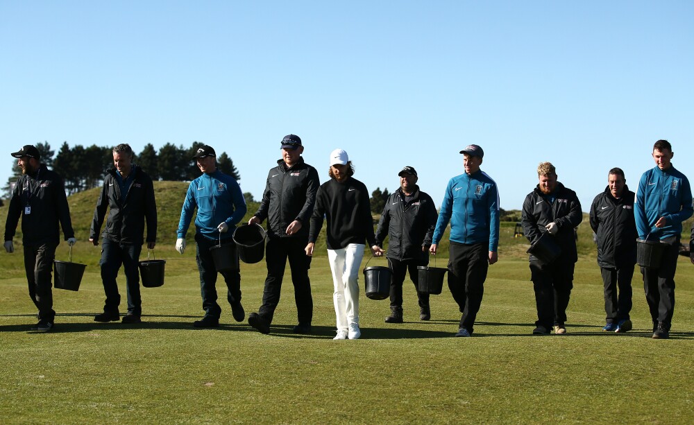 Tommy Fleetwood at Hillside Golf Course filling divots