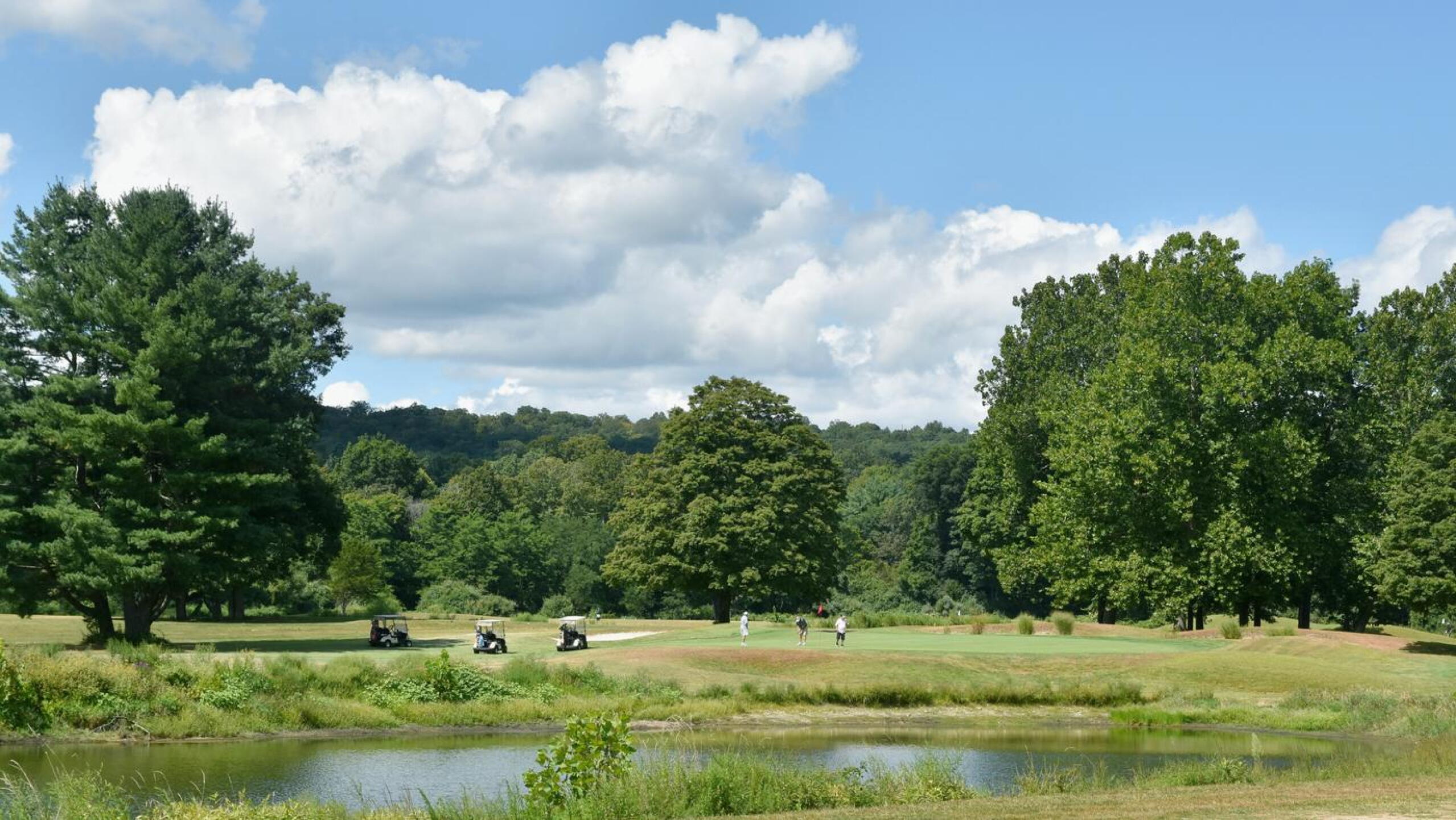 8th: A threesome is engaged in putting the eighth green. From my experience, for many golfers this is a challenging par-3–particularly from the back tees. (Photo submitted by AptlyLinked on 08/28/2025)