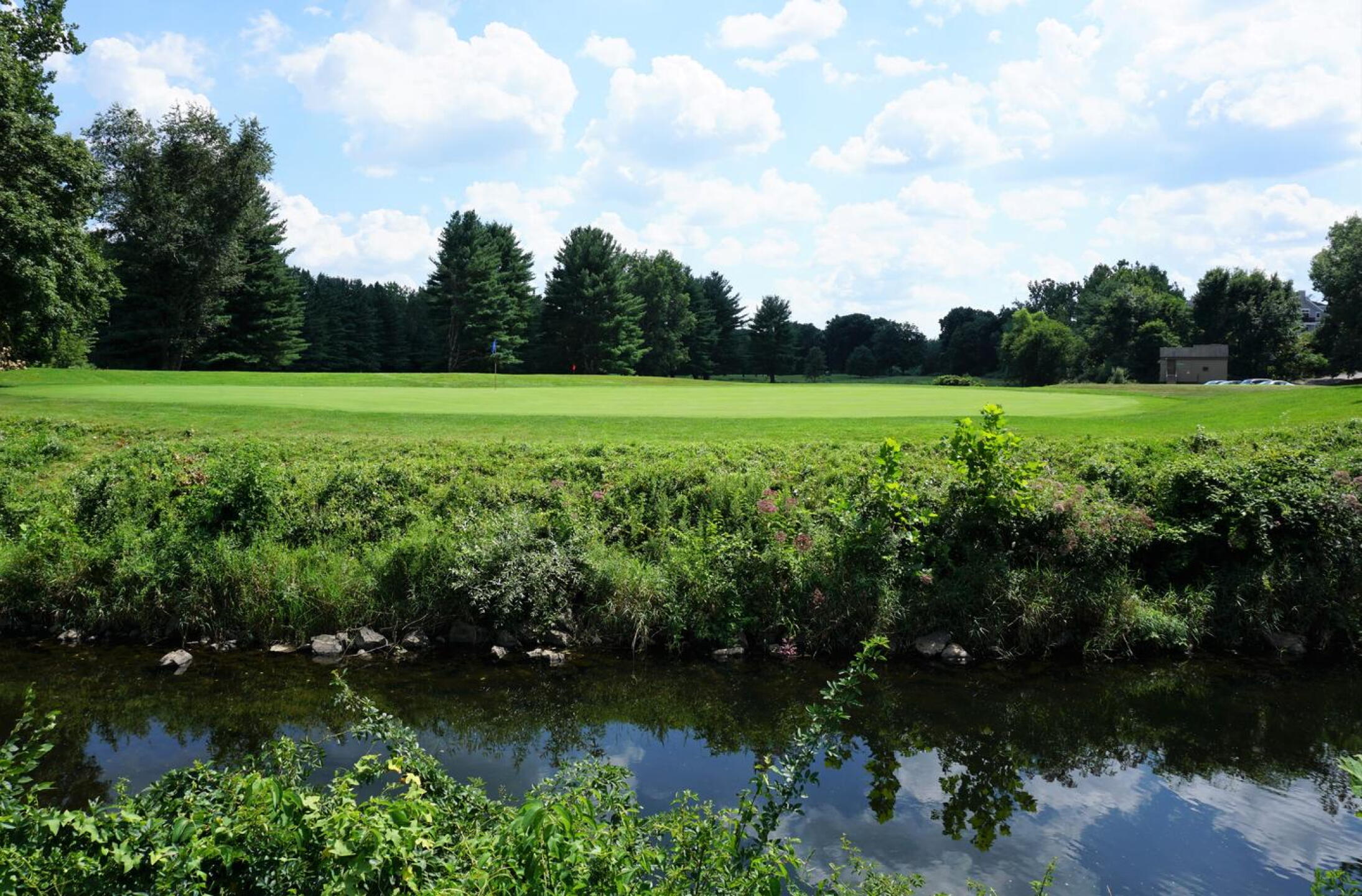 A river runs through it: On the ninth, you’ll be crossing the Pomperaug River to find this green on your final approach. (Photo submitted by AptlyLinked on 08/11/2020)