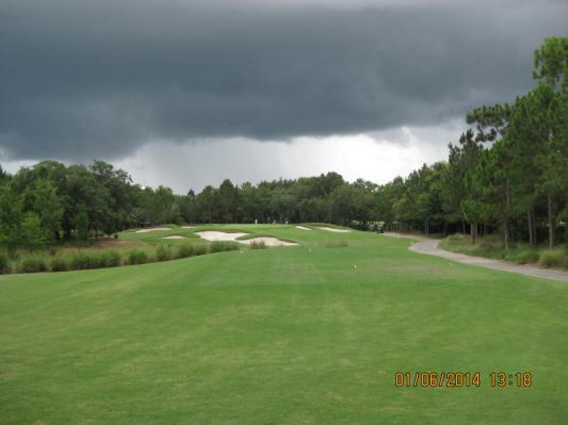 Grande Pines #4 Green from Tee box. Well protected elevated Green. Note the nasty rain clouds. (Photo submitted by Steve8905914 on 06/01/2014)