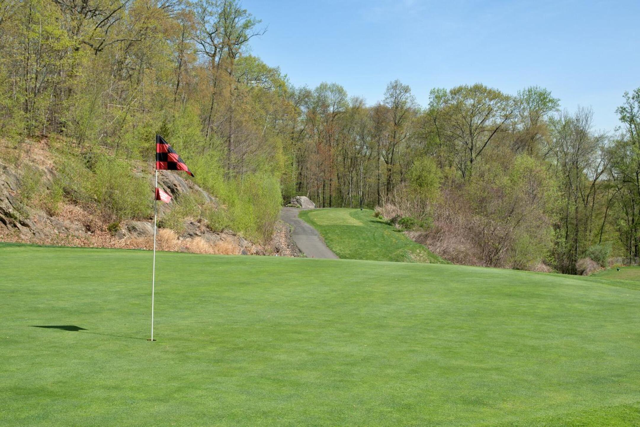 Playing uphill at 166 yards from its deepest tees (background), the sixth hole throws down the gauntlet to those who hope for a par. (Photo submitted by AptlyLinked on 04/30/2025)