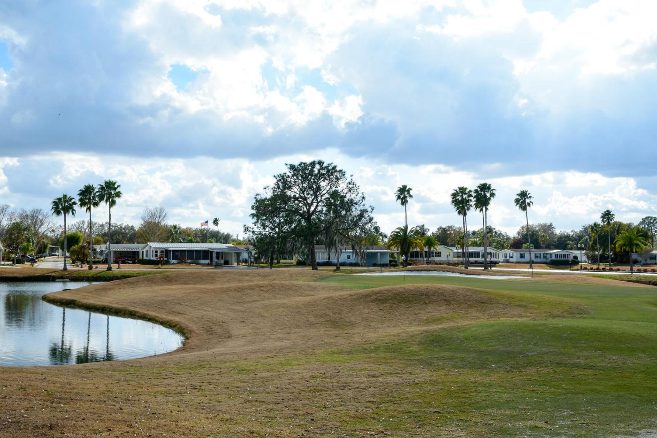 The sixth hole is a classic par-3 of 186 yards. A perimeter pond fortifies the green and its surrounds, while mounds make for more difficult lies on pitch shots. (Photo submitted by AptlyLinked on 02/18/2026)