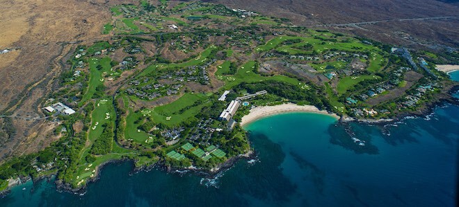 Mauna Kea Golf Course is one of the Big Island's top layouts, with its iconic par-3 third hole (lower-left part of photo) playing over a corner of the Pacific. (LuxuryBigIsland.com/Harold Clarke)