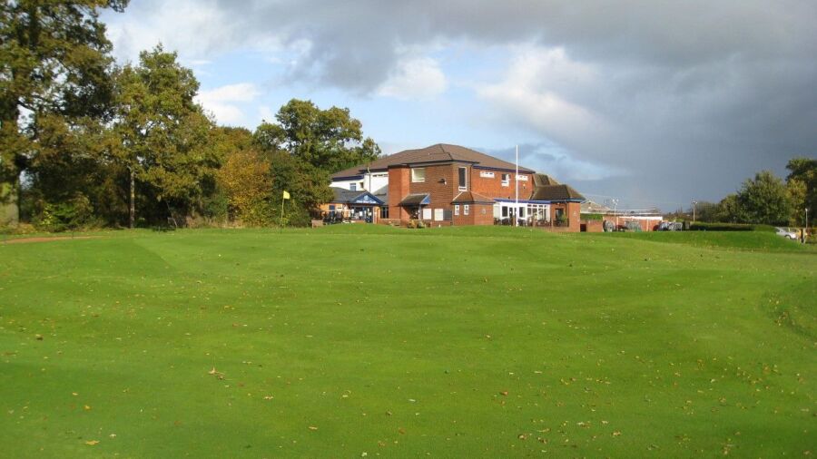 18th green and clubhouse at  Penn GC