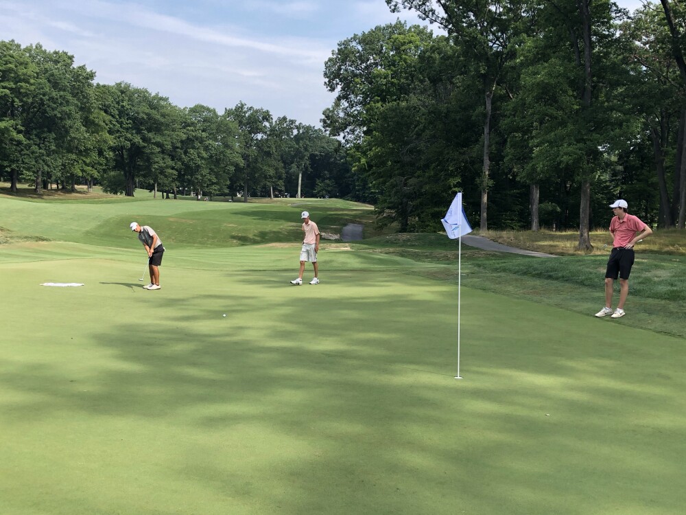 Putting with flagstick in