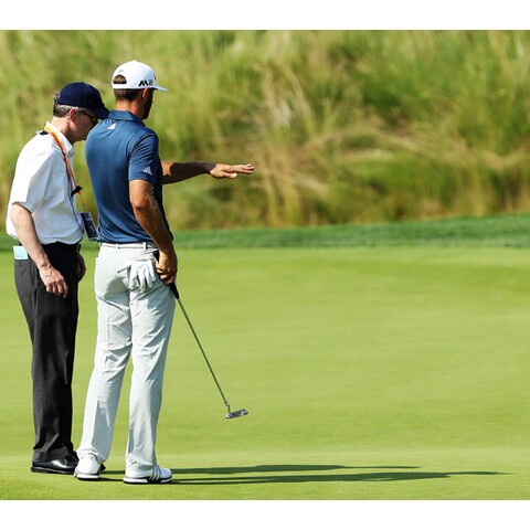 Dustin Johnson at Oakmont with rules official