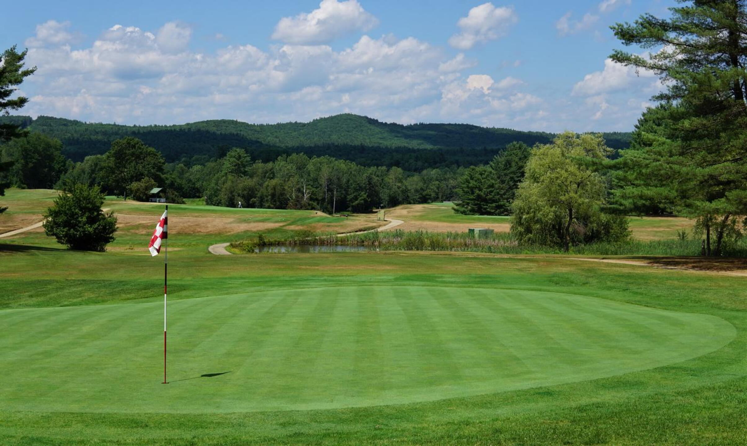 2nd: A classic Ross par-3 with a trap left of the green, and, just in front of the tee, a large pond to cross. (Photo submitted by AptlyLinked on 07/21/2022)