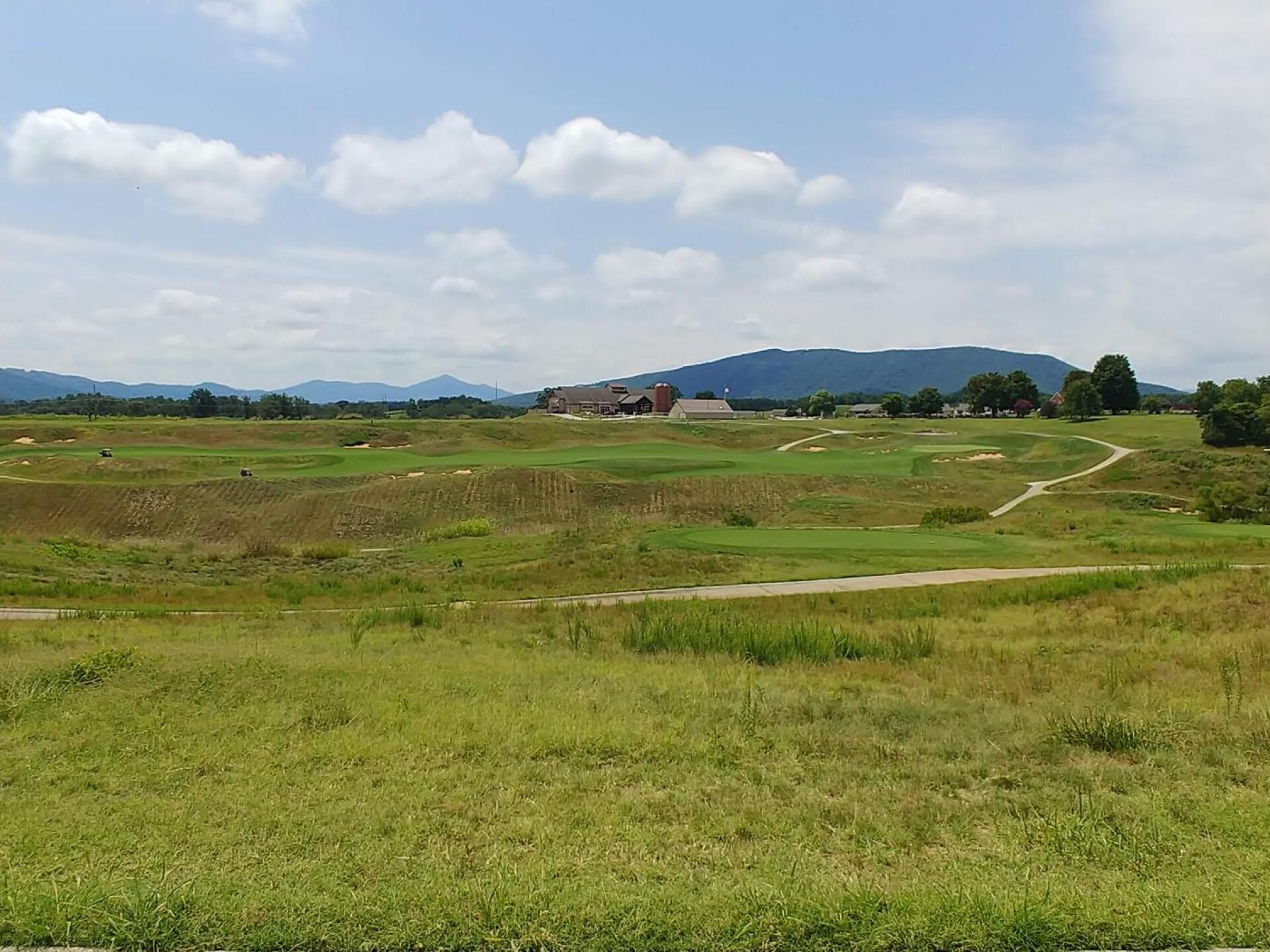 Looking across the valley toward the clubhouse from #2 green. (Photo submitted by Bombtech6316 on 08/08/2018)