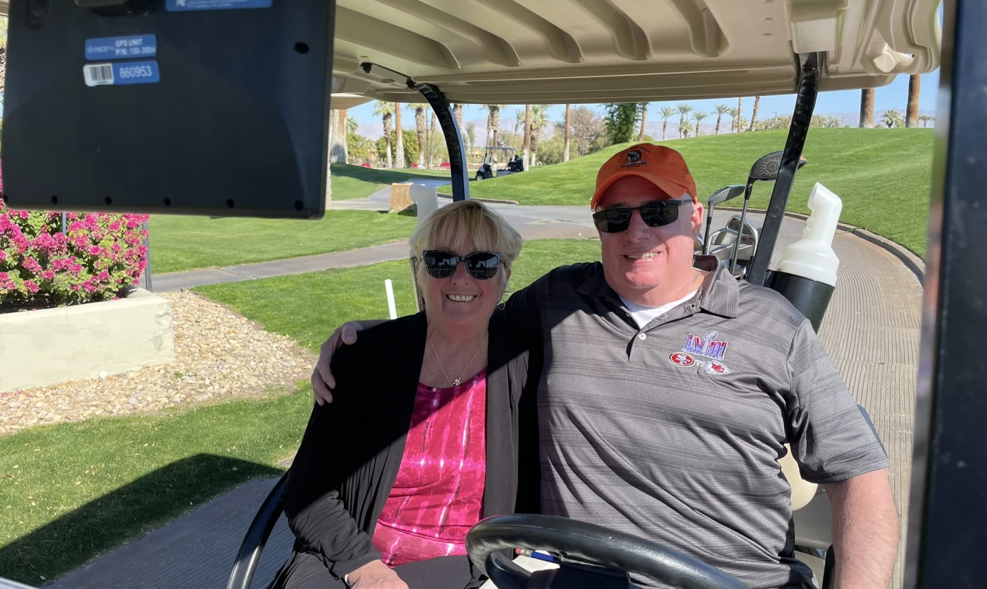 Non-golfing spouse riding a golf cart