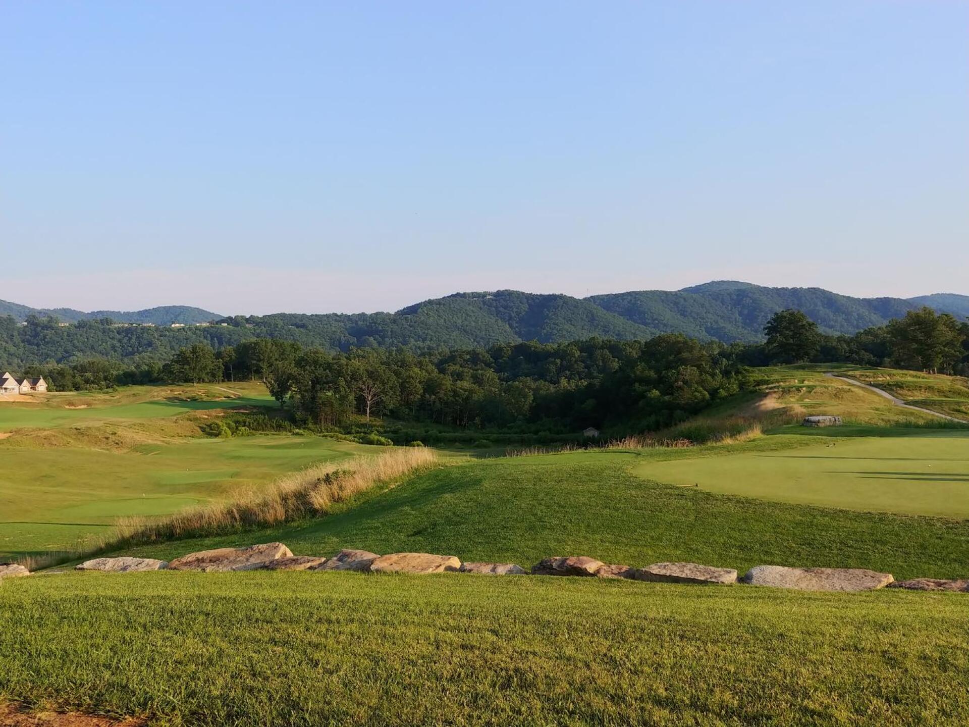 View from the patio looking over the practice facility. #10 fairway in the distance on the left and #18 tee box in the distance on the right. (Photo submitted by Bombtech6316 on 08/08/2018)