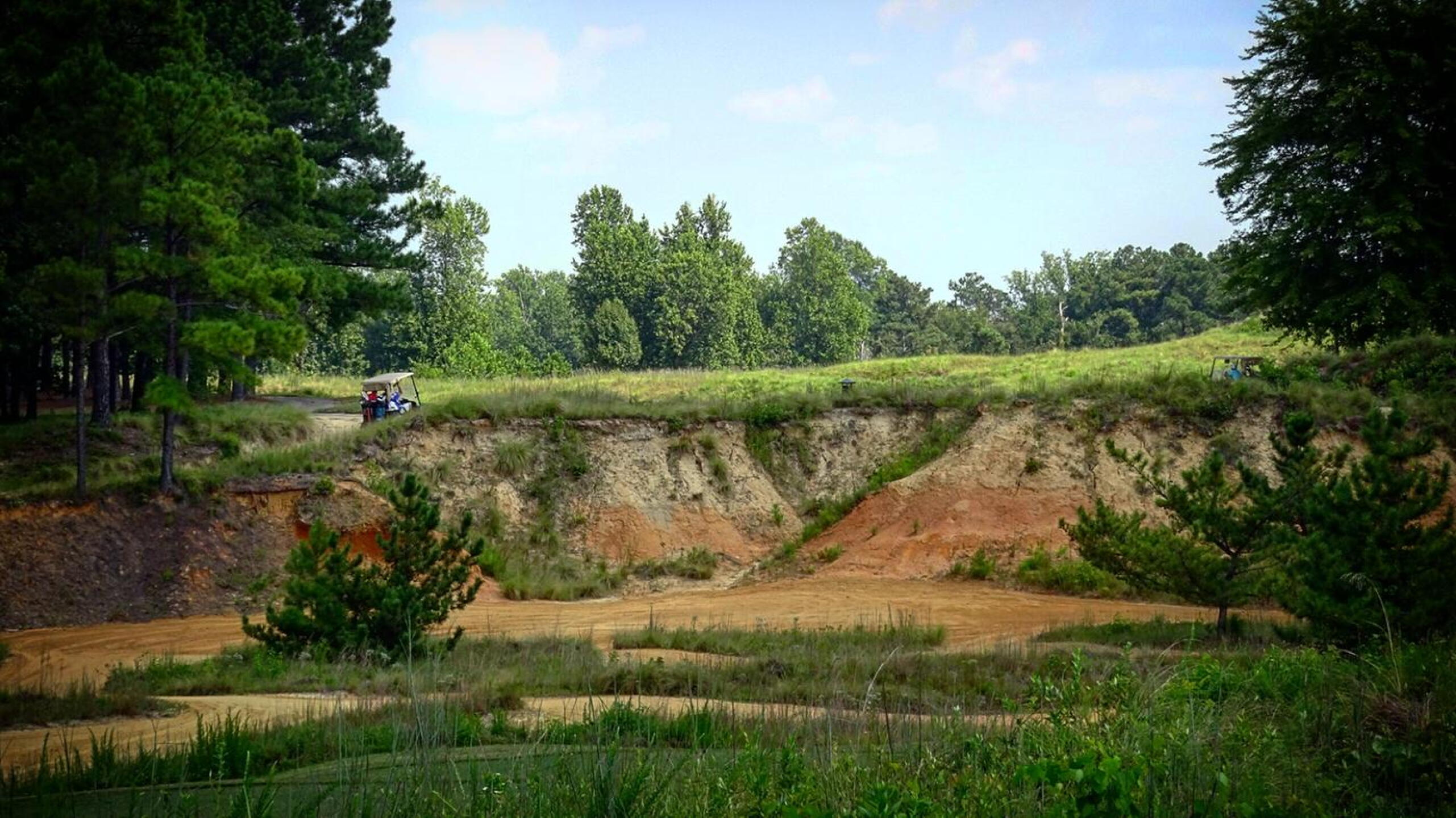 The sight of the 18th fairway from the tee. Yes, it is there, just beyond that massive cliff face. (Photo submitted by Back9Ben on 09/02/2018)