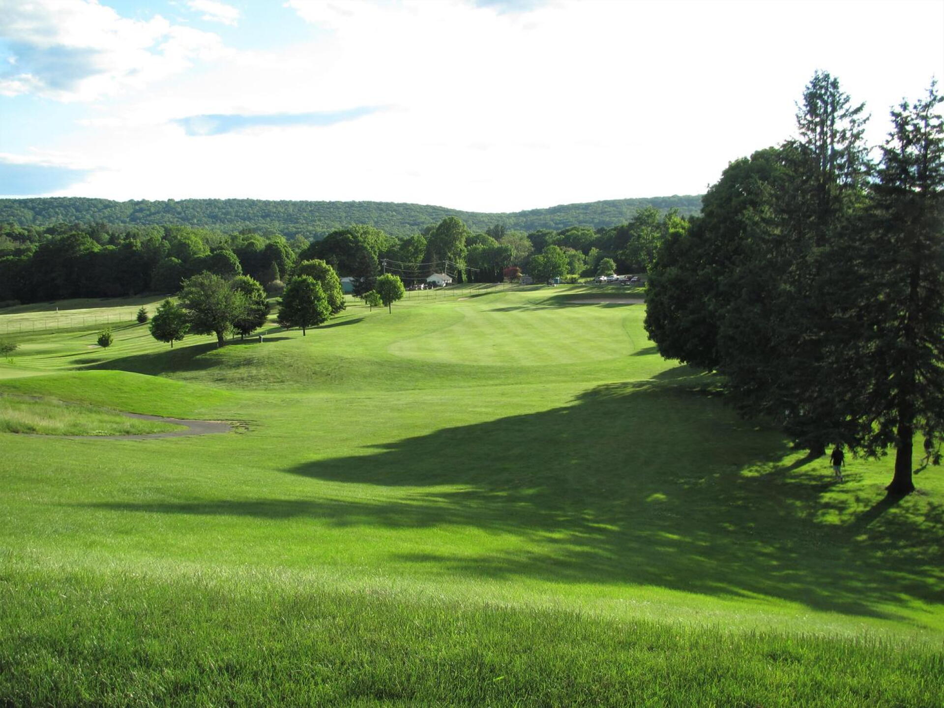 From tee nine: A view downhill to the green (behind bunker) on this four-par. (Photo submitted by AptlyLinked on 06/10/2020)