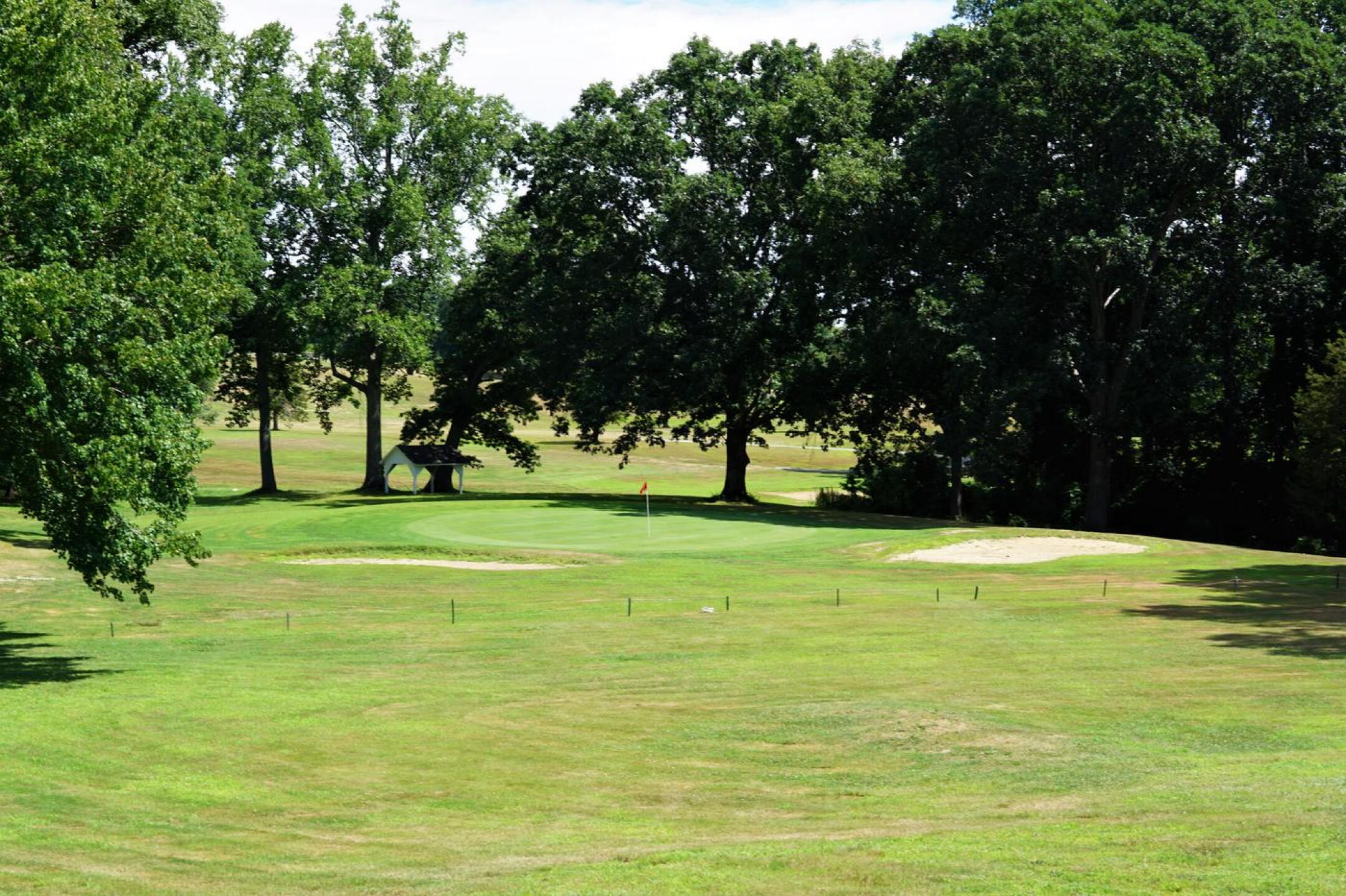 The par-3 seventh (seen from its left flank), plays from a high tee down to this green. (Photo submitted by AptlyLinked on 07/26/2022)
