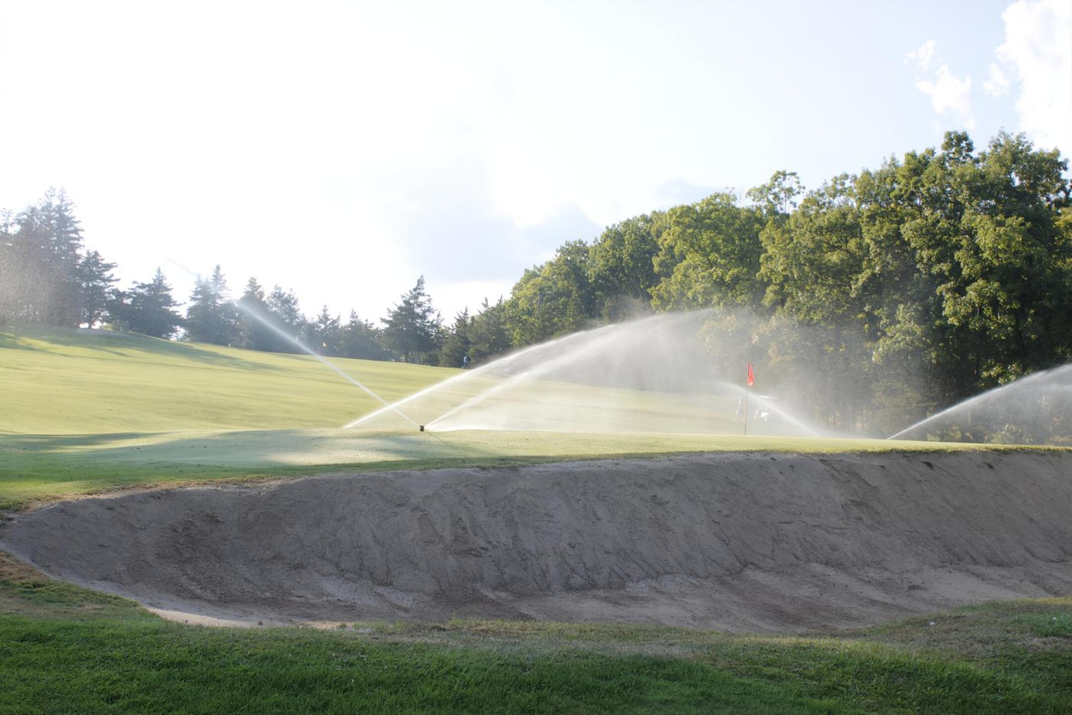 The sprinklers are in operation on green two (seen from behind). (Photo submitted by AptlyLinked on 09/22/2024)