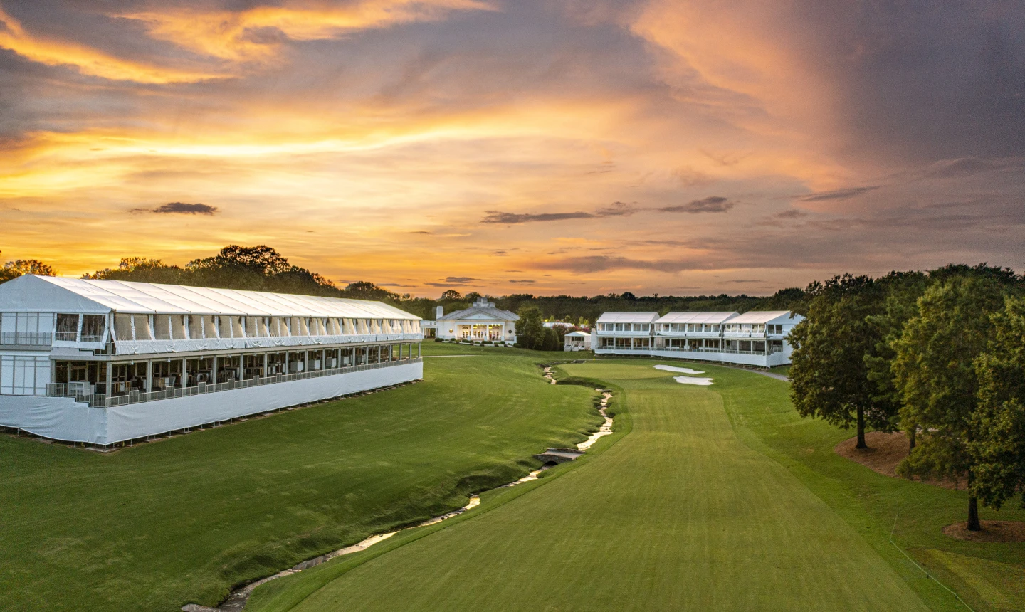 Golfers preparing on the driving range before the PGA Championship at Quail Hollow Club