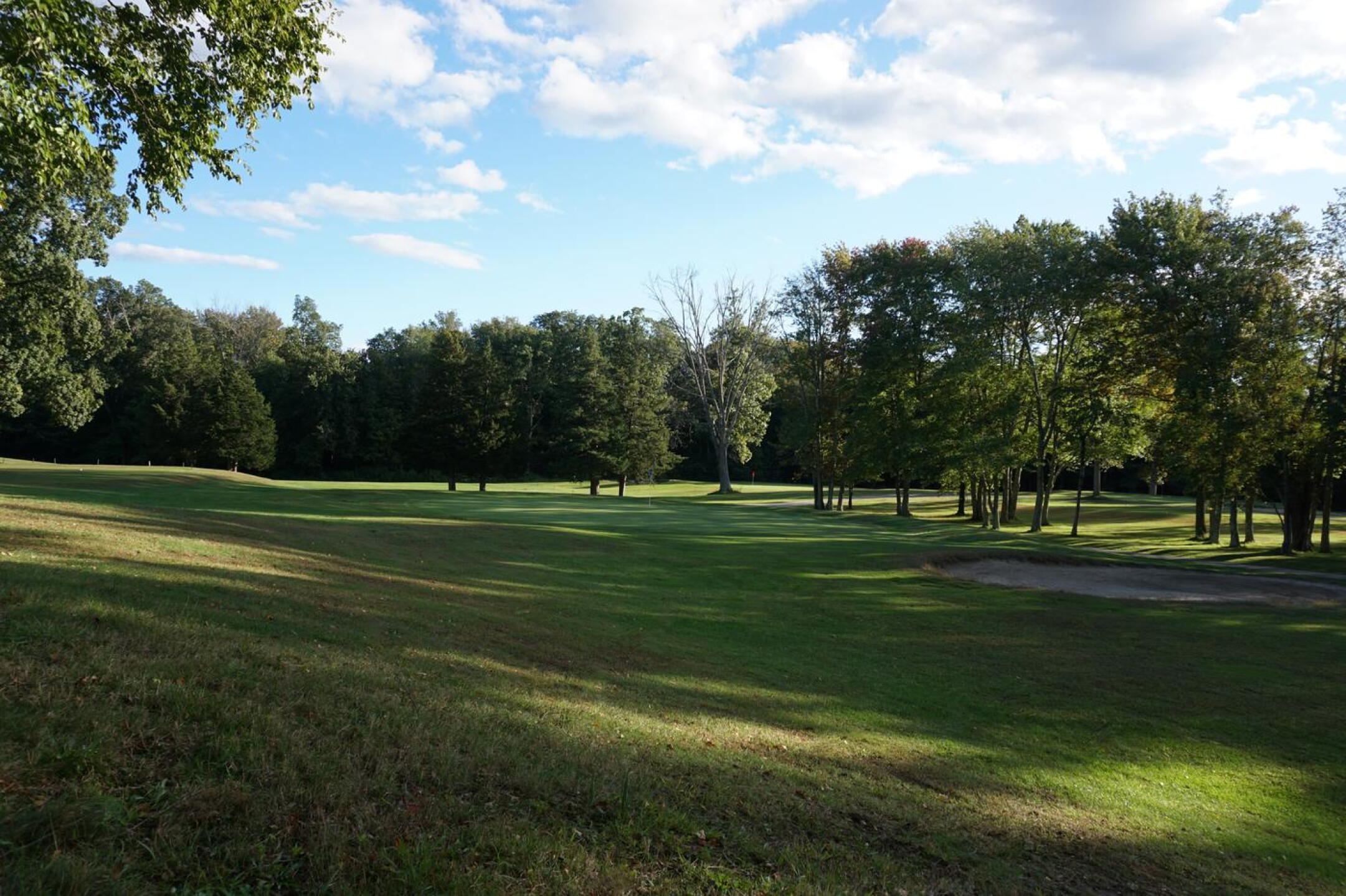 The par-5 sixteenth’s green, seen from the rough in the late afternoon shadows. (Photo submitted by AptlyLinked on 10/03/2021)