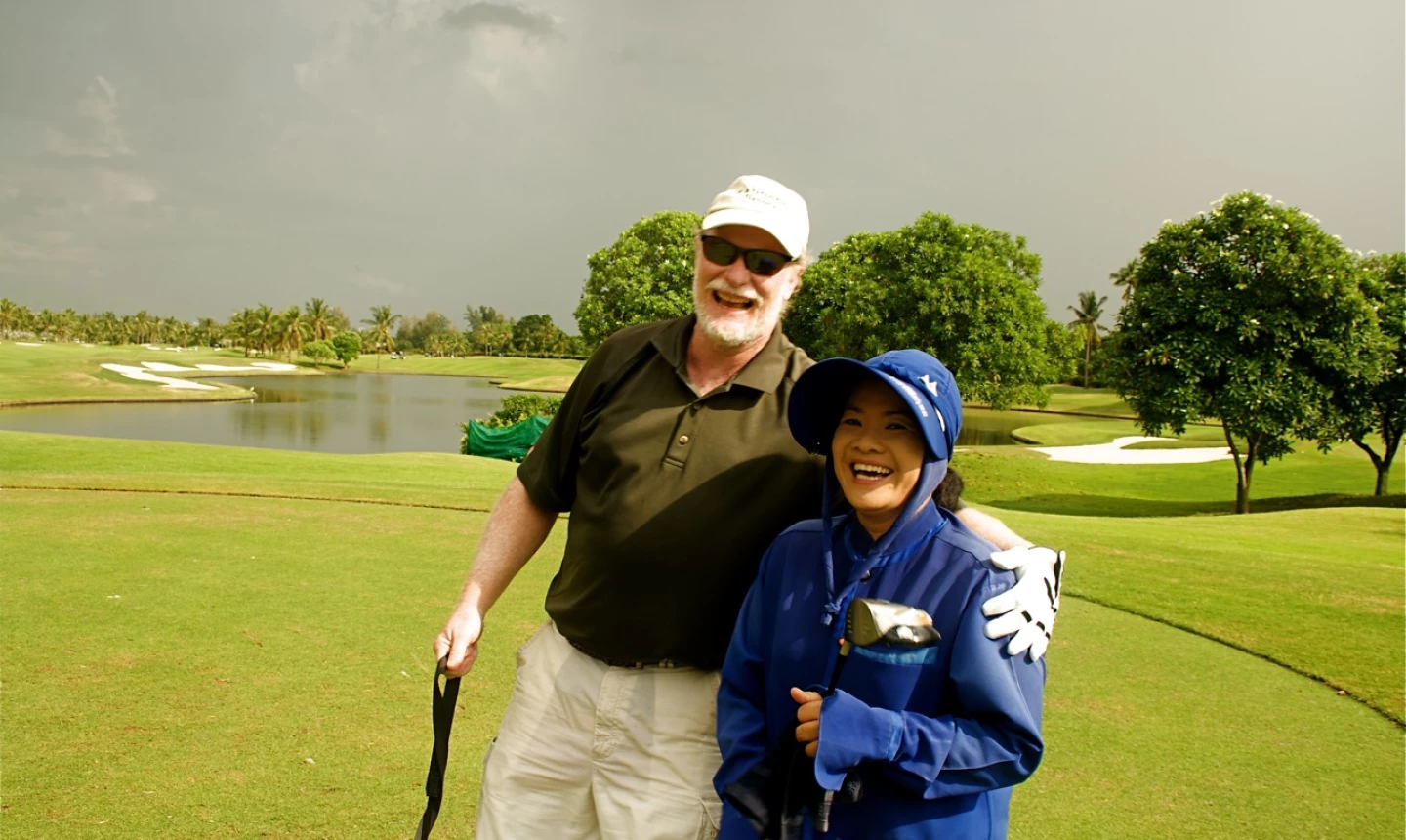 Golfer and Thai caddie