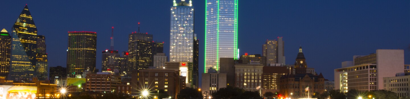 Dallas Texas skyline at sunset twilight night exposure of modern skyscrapers in downtown Dallas city across expressway