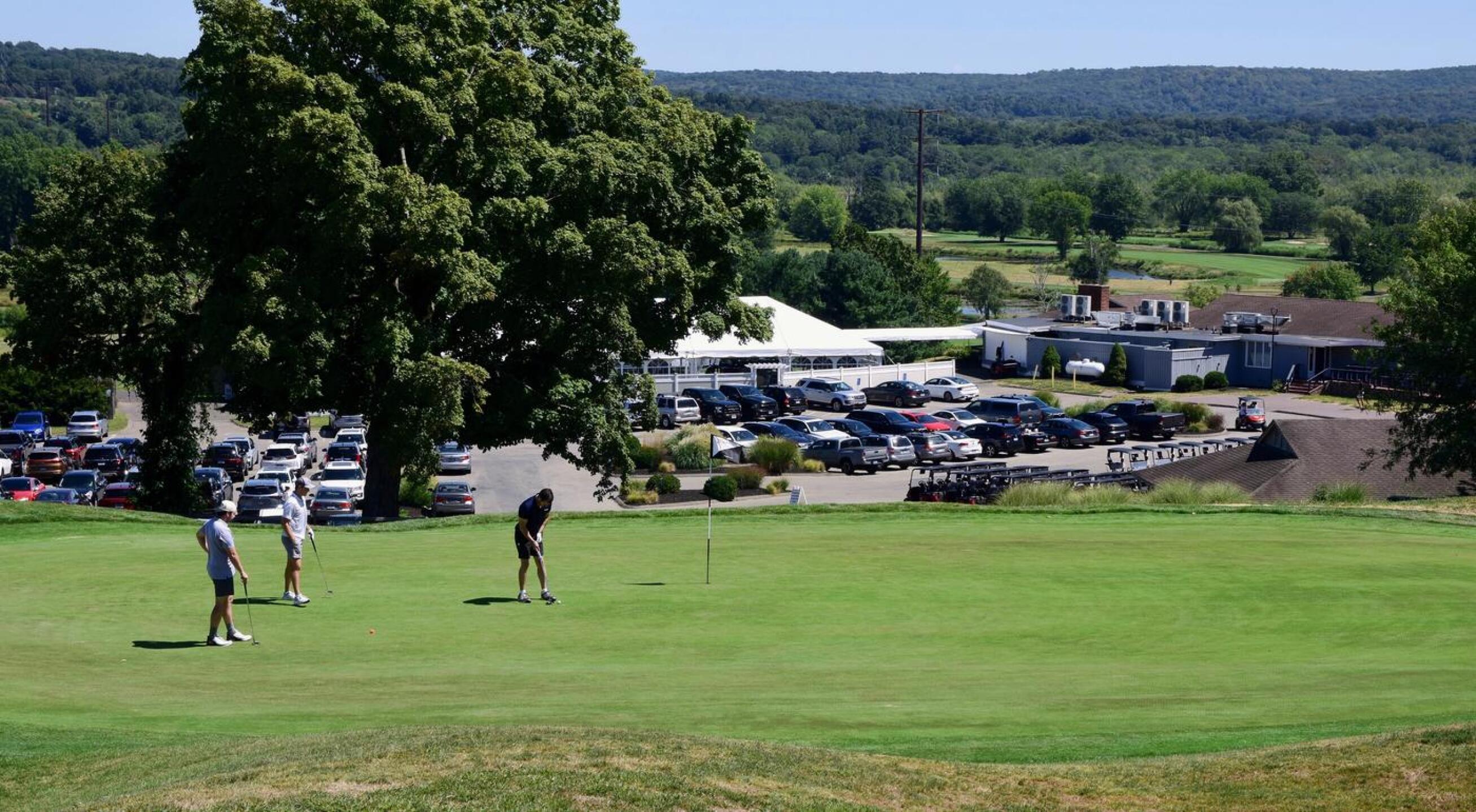 One of my playing partners (“L.”) prepares to hit his putt on the ninth as his friends look on. (Photo submitted by AptlyLinked on 08/23/2025)