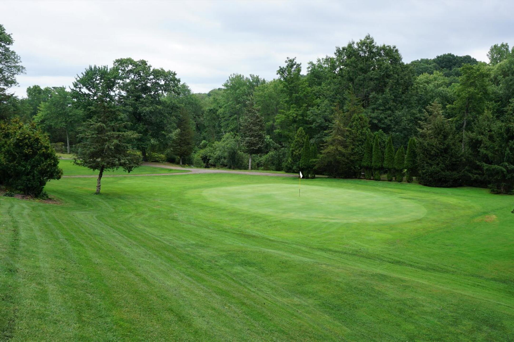 A view down to the third green from its right rear flank (standing on green five). (Photo submitted by AptlyLinked on 08/09/2021)